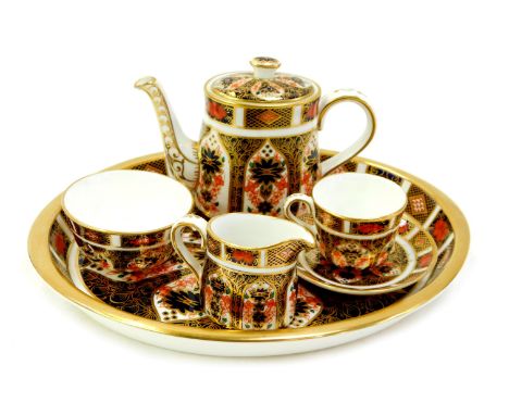 A Royal Crown Derby porcelain Old Imari pattern miniature tea service, pattern 1128, comprising oval tray, 19.5cm diameter, t