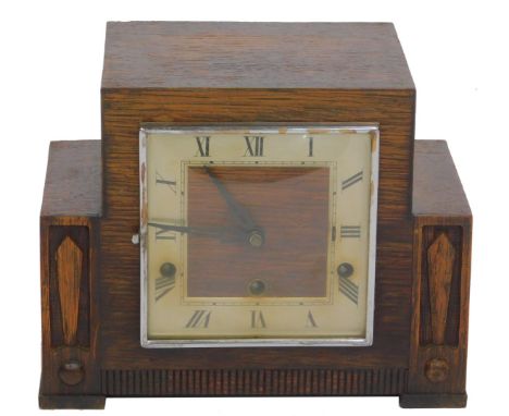 A 1950/60s oak cased mantel clock, the sectional top with a square silvered Roman numeric dial and black hands, eight day mov