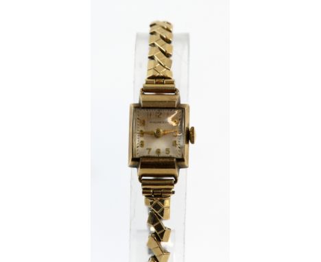 A  Record Ladies  9 carat gold cased wristwatch  the oval case  congaing a honeycomb signed dial  and fitted with a 15 jewel 