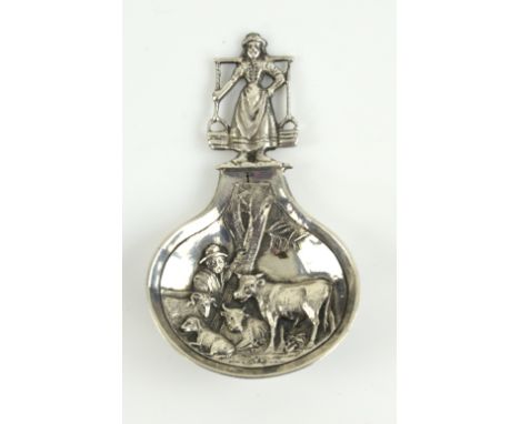 Silver caddy spoon, the bowl embossed with arable scene and the stem milk-maid, 6.5 cm long, 15 gr. .   