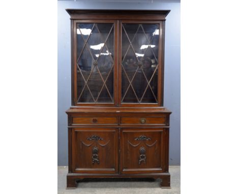 Early 20th century mahogany and glazed bookcase with two central drawers over two cupboards on bracket feet supportsProvenanc