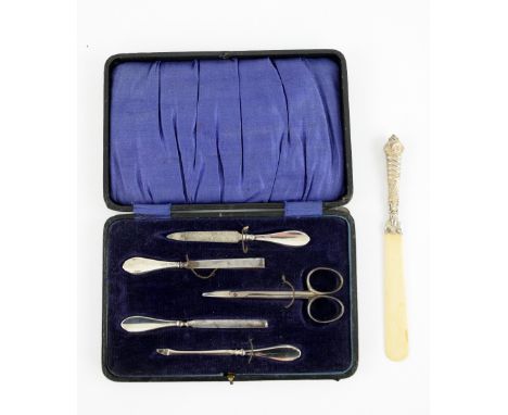 Silver-mounted manicure set, cased, and a Victorian silver-mounted ivory page-turner (2)PLEASE NOTE: THIS ITEM CONTAINS OR IS