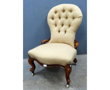 Victorian walnut button backed nursing chair on carved cabriole legs,.   