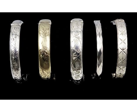 Silver-gilt bangle engraved with leaf design, Birmingham 1966 and four other silver hinged bangles, all hallmarked Condition 