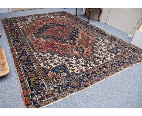 Heriz Carpet, North West Iran, circa 1940, the pale terracotta field of angular vines centered by an indigo medallion framed 