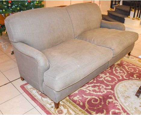 A Grey Upholstered Two Seater Sofa, on a mahogany frame with brass castors, 190cmA few marks and stains to both sides of each