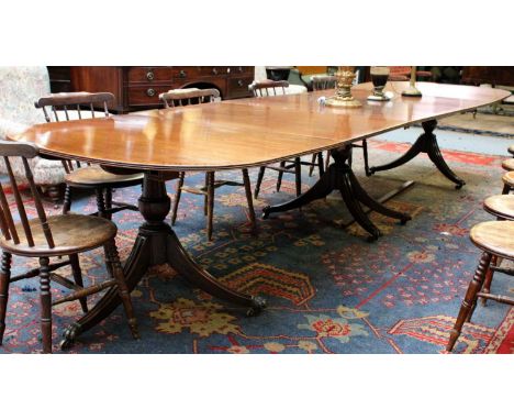 A Reproduction Crossbanded Mahogany Triple Pillar Dining Table, with three additional leaves, 410cm by 123cm by 74cmEstimate 