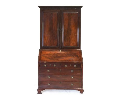 A George III Mahogany Bureau Bookcase, circa 1770, the moulded, dentil and blind fret-carved frieze above moulded cupboard do