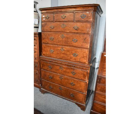 A Walnut Chest on Chest, first half of the 18th century, banded in mahogany with reeded and canted corners incorporating a br