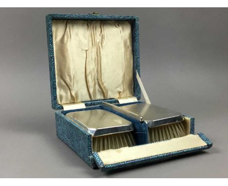 PAIR OF SILVER VANITY BRUSHES,along with a silver mounted comb, in a faux shagreen case