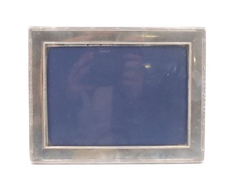 A modern silver fronted photograph frame, having ribbon and reed decoration and lightly engraved 'Merry Christmas, 2007', mah