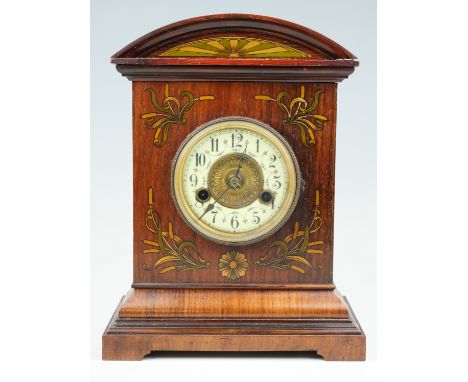 An early 20th Century German walnut mantle clock, having a brass movement striking on a gong, the architectural case having A