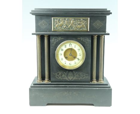 A Victorian black slate mantle clock, having a drum movement striking on a gong, with a Brocot escapement to the dial, the ca