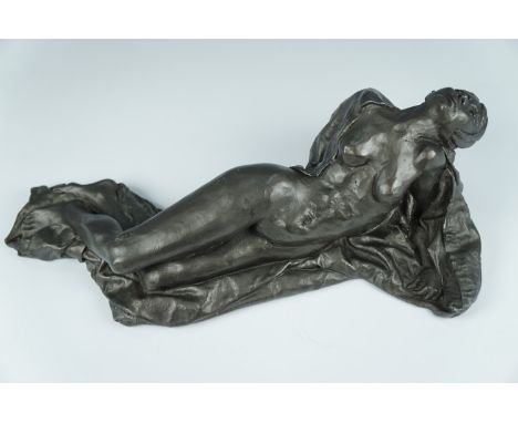 A late 20th Century cold cast bronze female nude sculpture, posed recumbent with her head back, partially draped with a sheet