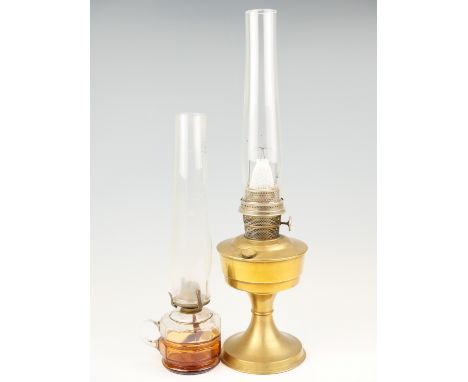 A brass oil lamp, together with a finger lamp, latter 44 cm