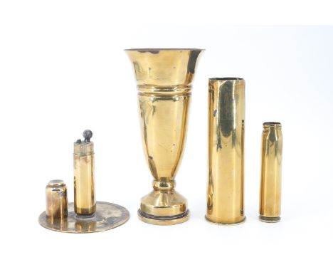 A Second World War trench art table cigarette lighter together with a 1943 trench art vase and inert brass shell cases respec