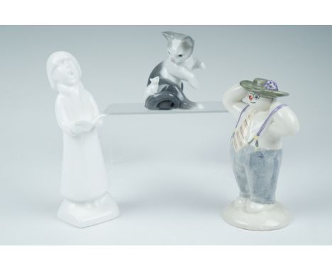 Two Royal Doulton figurines, Stylish Snowman, 13 cm together with Carol Singer Boy, 15 cm, and a Lladro cat