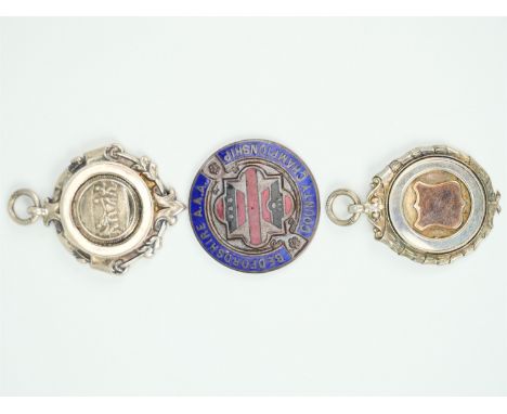 A 1920s tug of war silver prize watch chain fob medallion, together with one other Sterling white metal medallion and an engr