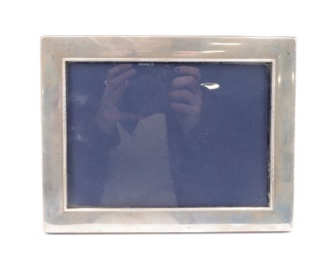 A contemporary silver faced photograph frame, having a mahogany back and stay, (portrait or landscape), Sheffield, 2011