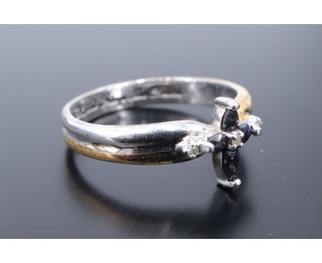 A contemporary sapphire and diamond ring, comprising four pendeloque cut sapphires in a cruciform setting by centred and term