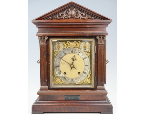 An early 20th Century German scumbled walnut mantle clock, striking and chiming on gongs, in an architectural case, 31 cm x 2