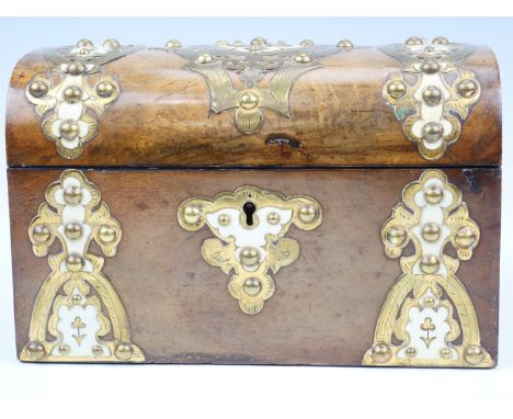 A Victorian walnut veneered dome top two compartment tea caddy, decorated with ivory, and pierced and engraved brass embellis