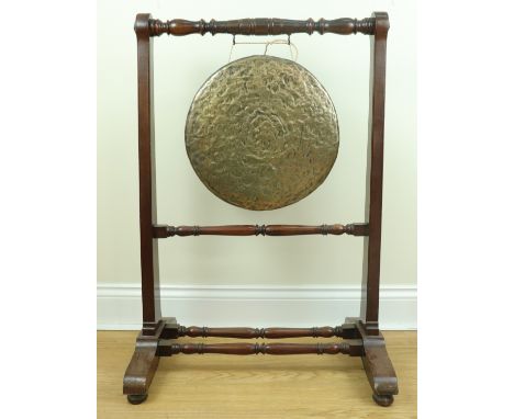 A late Victorian bronze dinner gong and mahogany stand, 63 cm x 95 cm high