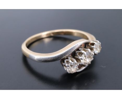 A vintage twist-set three-stone diamond ring, the stones of approx 0.5 ct aggregate weight platinum claw set on a yellow meta