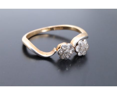 A vintage double daisy head diamond ring, the two clusters each of approx 5 mm, set on 18 ct gold, P/Q, 2.7 g, (a/f)