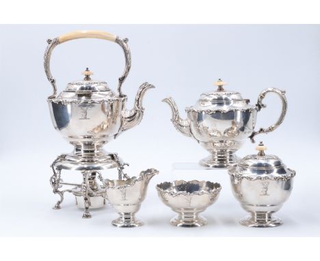 An Edwardian silver five piece bachelor teaset, comprising a spirit kettle, teapot, milk jug, sugar basin, and tea caddy, bei