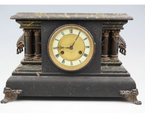 An early 20th Century German faux slate and marble mantle clock, having a Junghans movement, striking on a gong, the architec