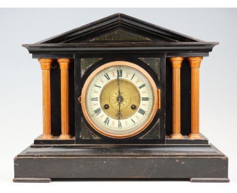 An early 20th Century German faux slate mantle clock, having a Junghans movement, striking on a gong, the architectural case 