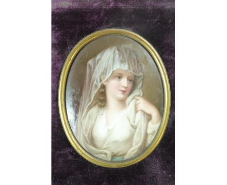 A 19th Century painted porcelain portrait miniature, depicting a veiled young lady, in a velvet and gilt metal frame, 8 x 6.5