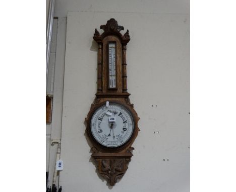 An Oak Encased Wall Barometer With Circular Dial