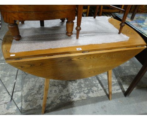 An Ercol Oak Drop Leaf Dining Table