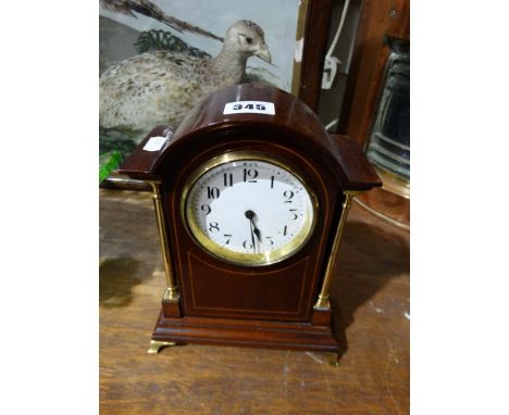 A Mahogany Encased Mantle Clock With White Enamel Dial
