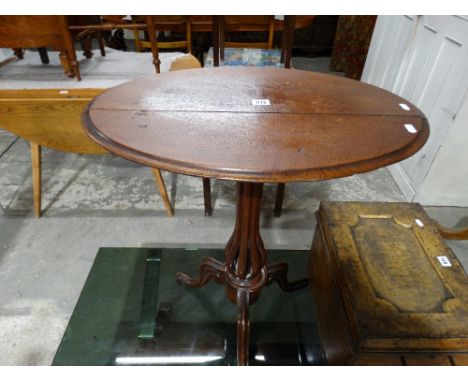An Oval Topped Pedestal Tripod Table