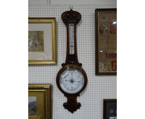 An Oak Encased Wall Barometer With Circular Dial