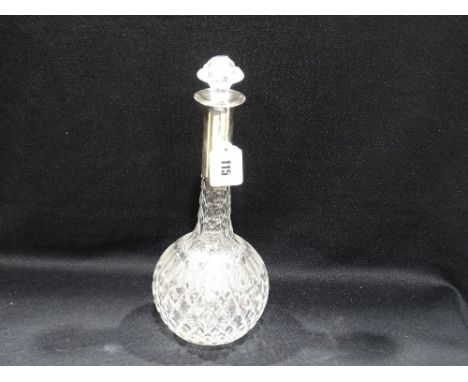 A Circular Based Narrow Necked Glass Decanter With Silver Collar
