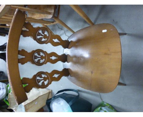 Pair of Ercol Dining Chairs with Elm Seats, the splats carved with circular motifs