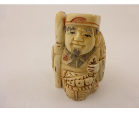 Signed oxbone netsuke of a man with basket and stake