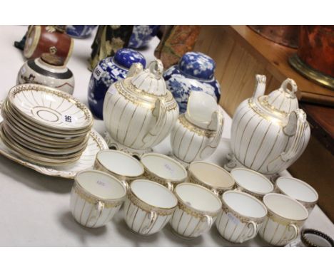 Victorian Rockingham Style Tea Service comprising Teapot, Milk Jug, Lidded Sugar Bowl, Cake Plate, Ten Tea Cups and Eleven Sa