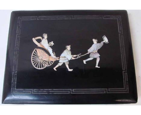 An early 20th century Japanese black lacquered photograph album, the front cover decorated with carved bone and mother of pea