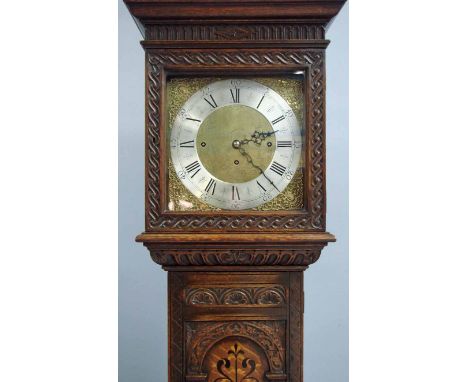 A good quality reproduction oak longcase clock, the brass and silvered 33cm dial with spandrels, Roman numerals and three win