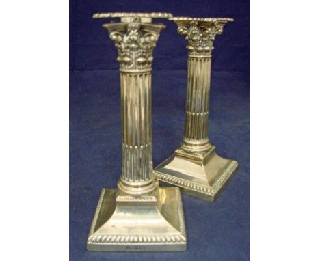 A pair of Edwardian silver Corinthian column candlesticks, gadrooned detachable drip pans with matching marks, fluted columns