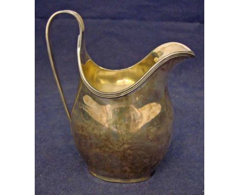 An early 20th century silver milk jug of helmet form, ribbed rim and loop handle, Chester 1904, 3.57oz, 11.5cm high