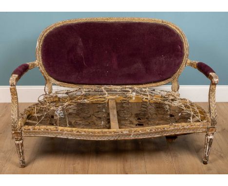 An antique 18th century style French small sofa with gilt carved wood frame, serpentine fronted seat and fluted tapering fron