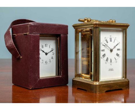 A Brass cased carriage timepiece, the enamel dial signed Tanner, Cirencester, 18cm high with the handle up, and a further sma