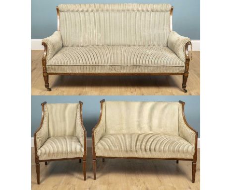 An Edwardian settee with scrolling armrests on raised squared tapered legs, veneer decorated with flowers at the top of the a
