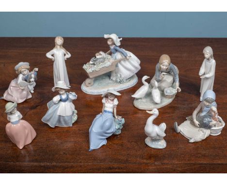 An assortment of various Lladro and Nao ceramics, including five Lladro figures of girls and a duck and four Nao figures (9)U